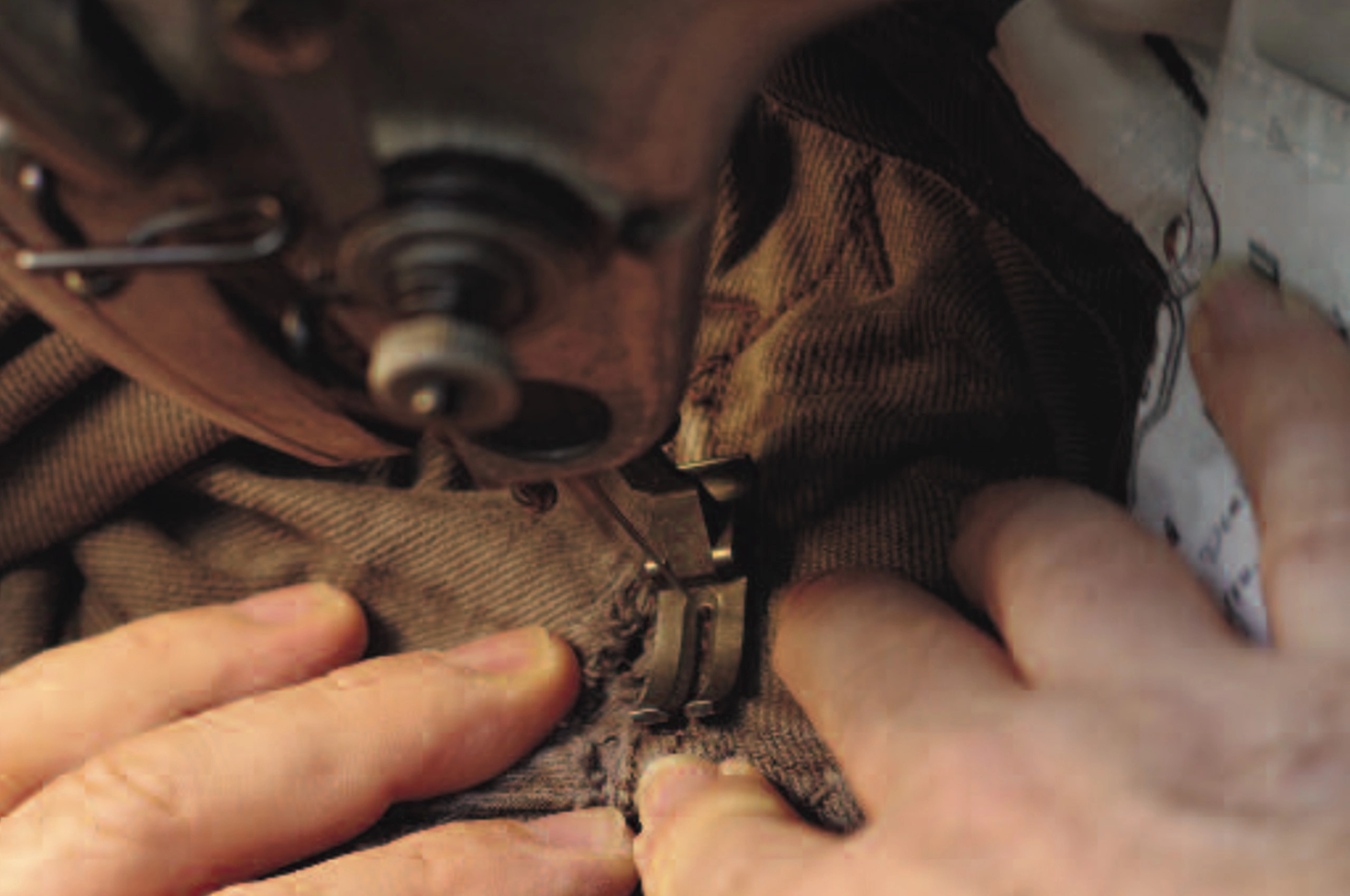 The hands of an artisan sewing Hollyowl’s luxury dog collection.